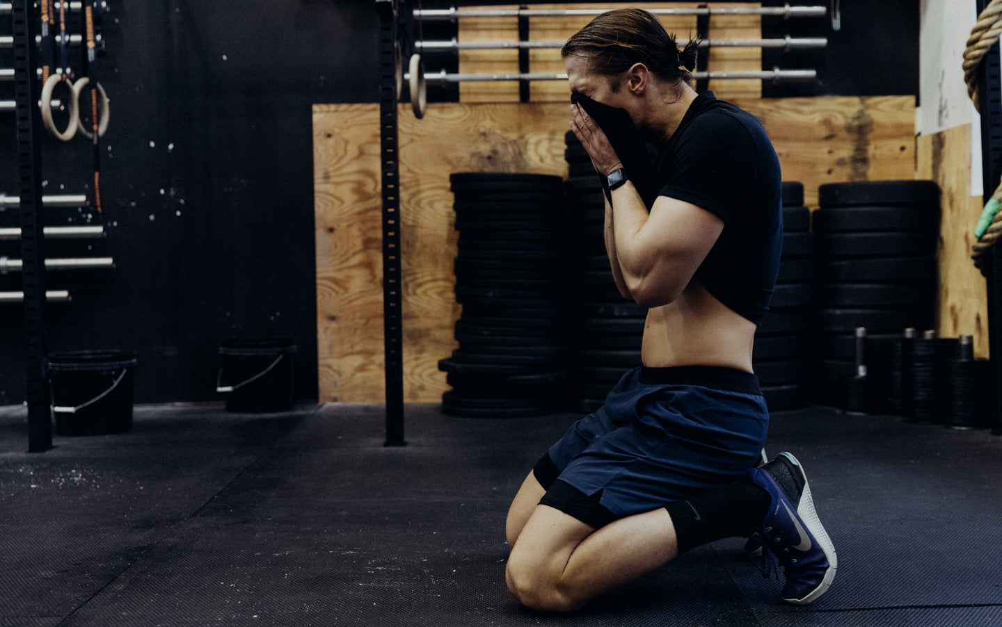 Man drying off face while wearing the Interval Short