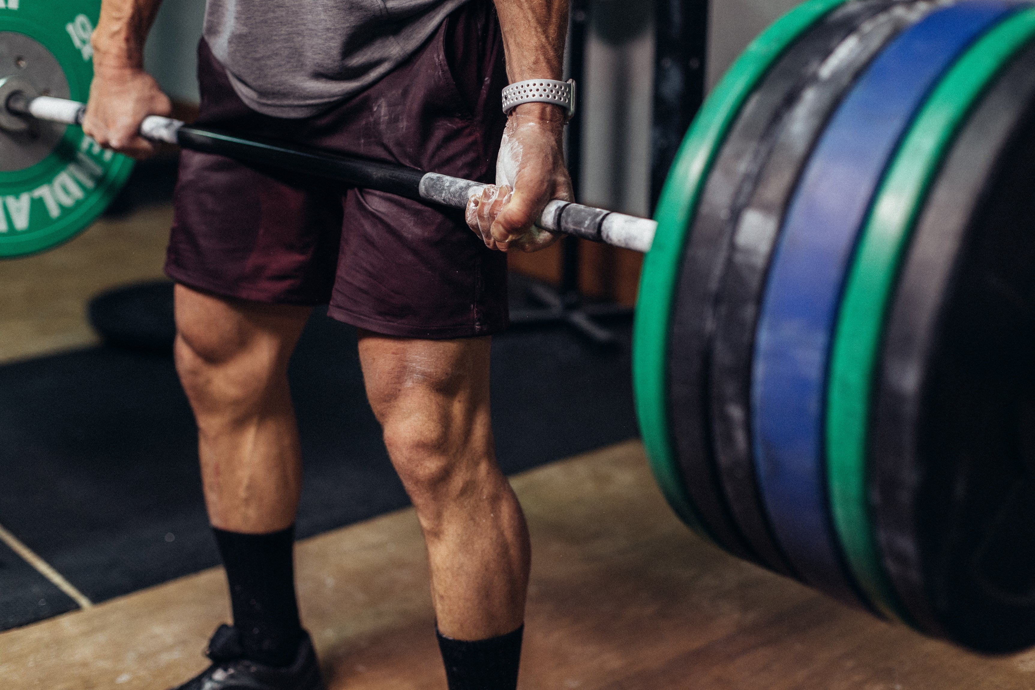Holding a barbell with chalk covered hands